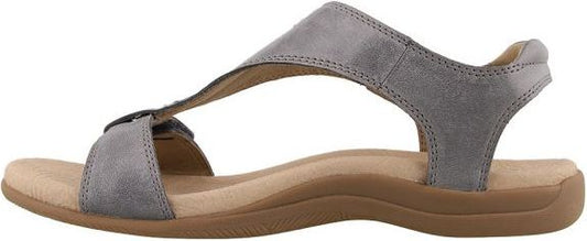 Gray sandal with t-strap and flat brown sole.