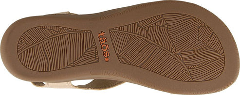 The outsole of a sandal featuring a leaf pattern and the word "Taos".