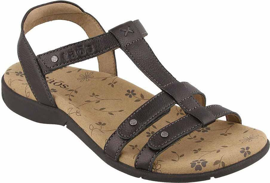 Dark grey leather T-strap sandal with floral patterned footbed and TAOS branding.
