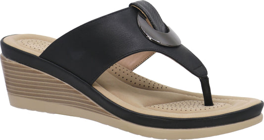Black wedge sandal with toe post and circular embellishment.