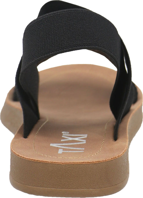 Back view of a sandal with a tan sole, black elastic straps, and visible 'TIXI' logo on the footbed.