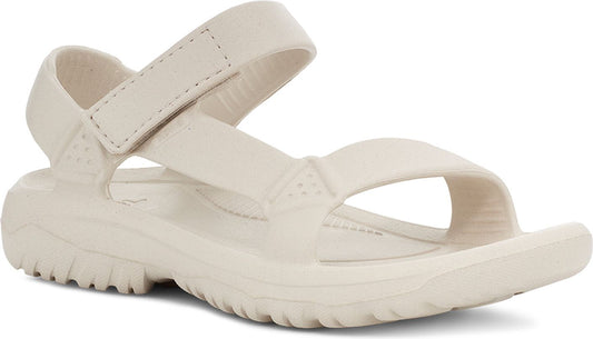 Beige sandal with adjustable hook and loop straps.