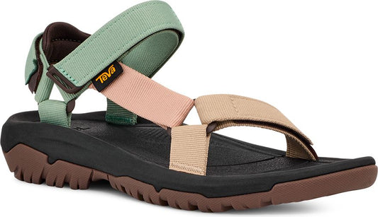 Multi-colored sandal with adjustable velcro straps: light green around the ankle, tan over the toes, peach across the instep, black sole with brown treads.
