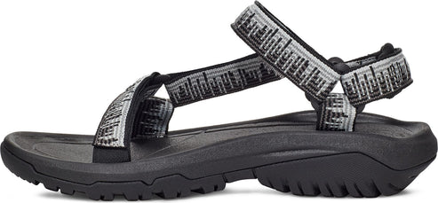 Side view of a black sandal with decorative straps.
