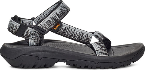 A sandal with black patterned gray straps and a chunky black sole.