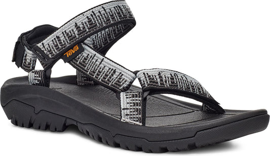 A sandal with black soles and gray-white patterned straps.