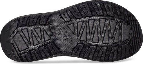 Bottom view of a black shoe showcasing a complex tread pattern of triangles and rectangles.