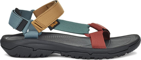 A sandal with blue, tan, green and red straps on a black sole.