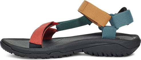 A sandal with a coral, dark green, tan, and blue color scheme.