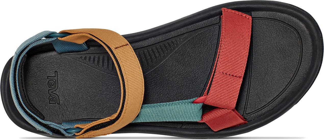 A black sandal with red, tan, and teal nylon straps.