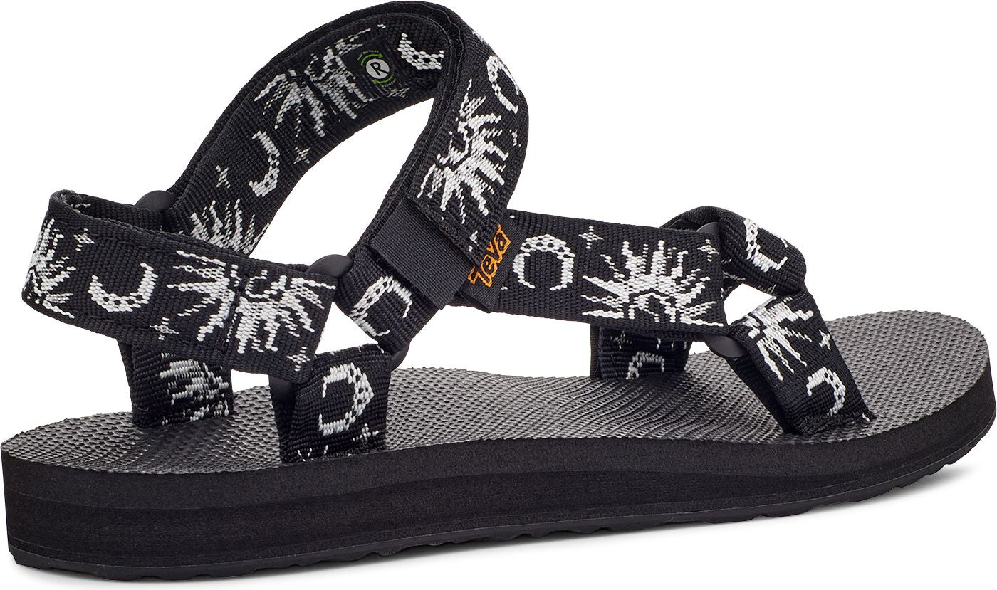 Black strappy sandal with sun and moon design.