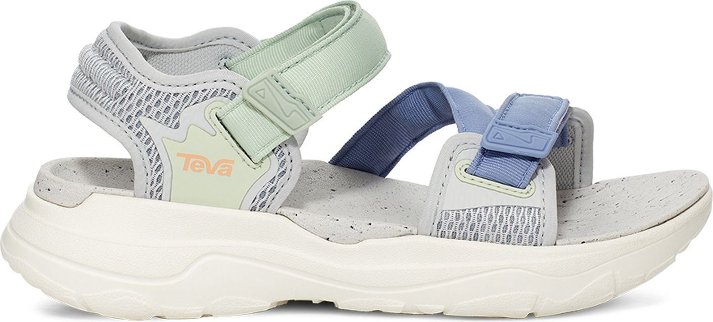 A sandal with adjustable hook-and-loop straps in light blue and green hues, set on a chunky white sole.