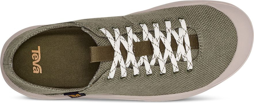 A green slip-on shoe with white laces and a light tan sole.