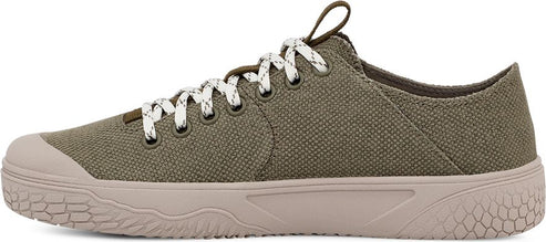Side view of a green canvas sneaker with white laces and a tan sole.
