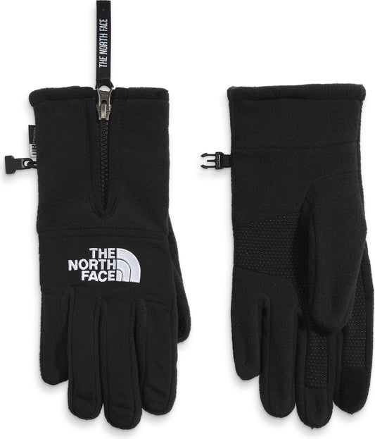 A pair of black gloves, one laying with the back of the hand showing an adjustable strap, zipper and 'THE NORTH FACE' logo, the other with the palm facing up and showing a textured pattern.