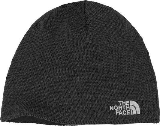Knitted dark grey beanie hat with the words THE NORTH FACE vertically stacked in a silver square at the bottom.