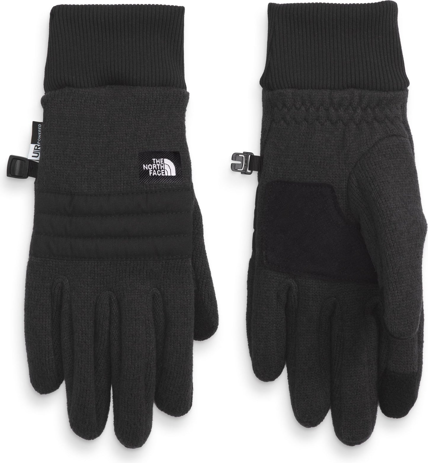 Two black gloves with ribbed cuffs are displayed side by side. The left glove shows the back side and features horizontal quilting and a small white square logo. The right glove shows the palm side with reinforced fabric and a textured pattern.
