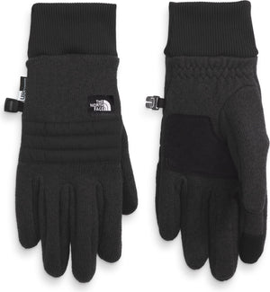 Two black gloves with ribbed cuffs are displayed side by side. The left glove shows the back side and features horizontal quilting and a small white square logo. The right glove shows the palm side with reinforced fabric and a textured pattern.