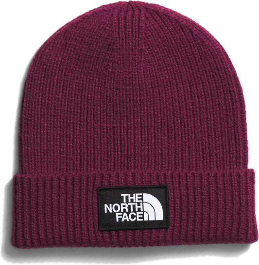 Maroon knit beanie with a black patch showing "THE NORTH FACE" in white.