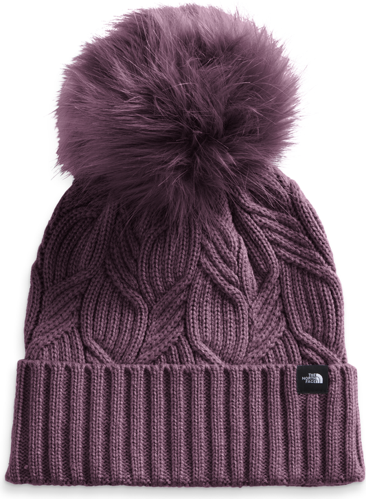 Cable-knit beanie with a large pompom.