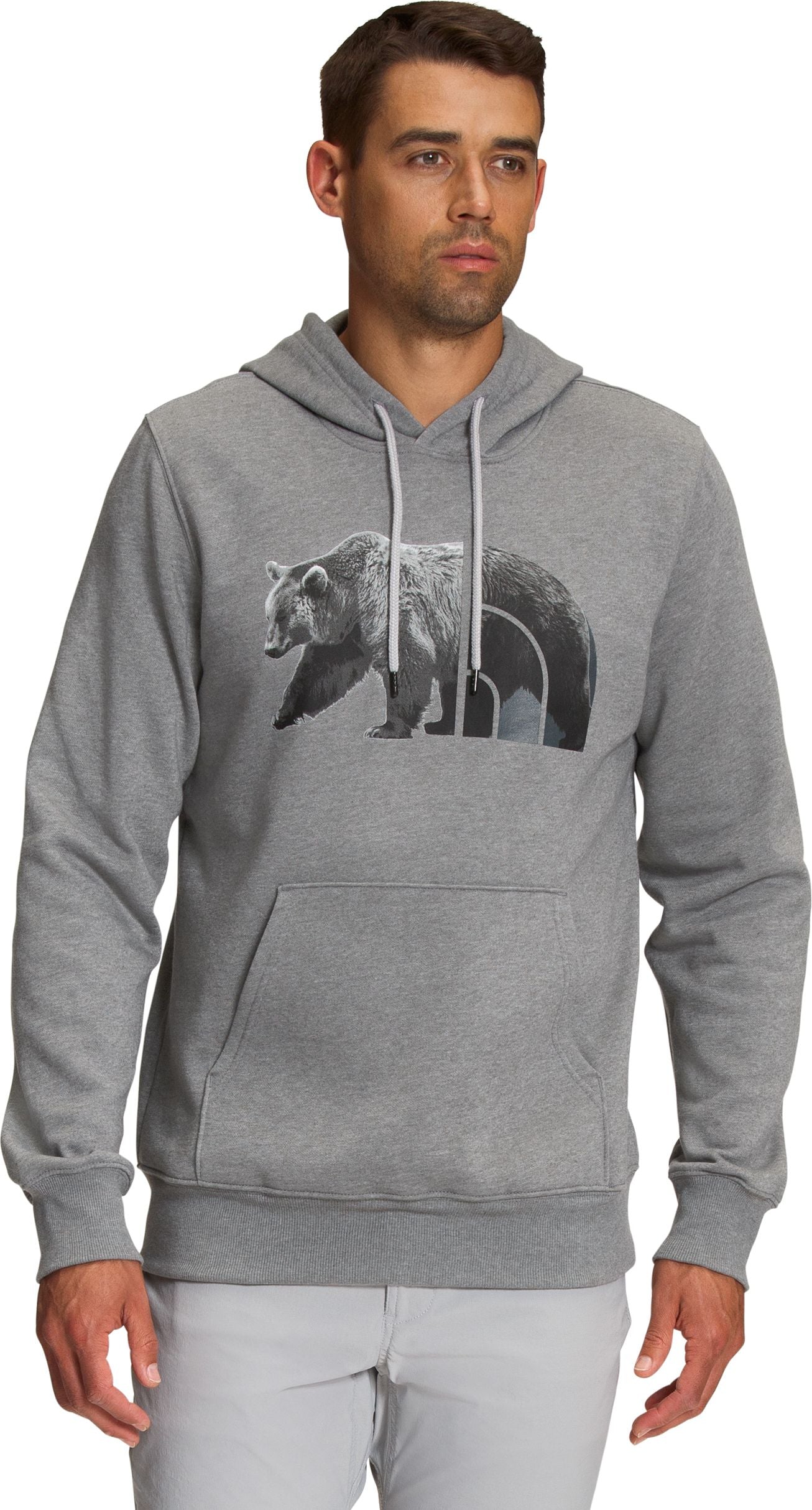 Man wearing a gray hoodie with a bear graphic.