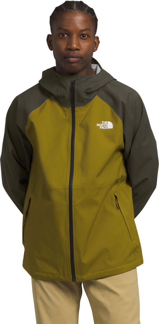 A man in a two-tone green and olive jacket with a hood and a zipper.