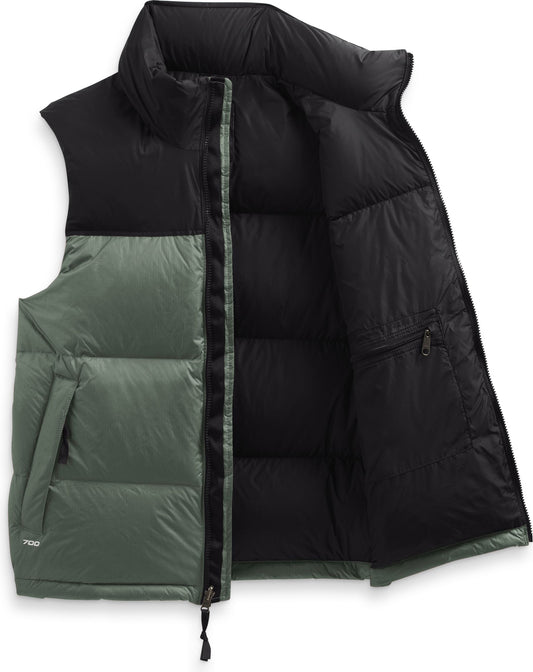 Puffer vest in a color block pattern with black on the top and green on the bottom and a zipper closure.