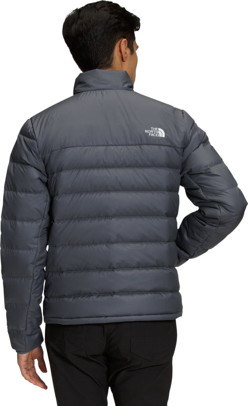 Gray quilted jacket with a white logo on the upper-left.