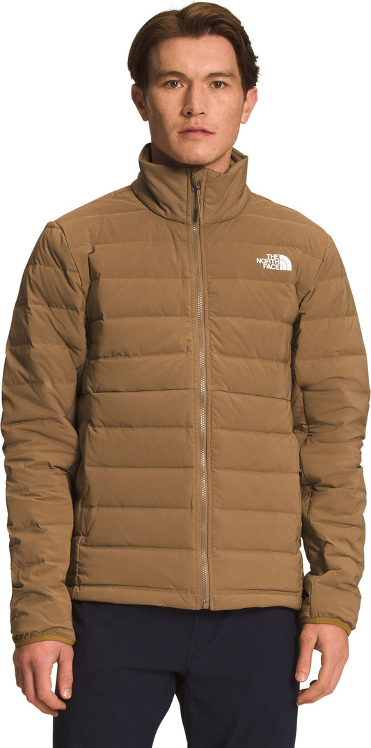 A man wearing a brown quilted jacket with a zipper.