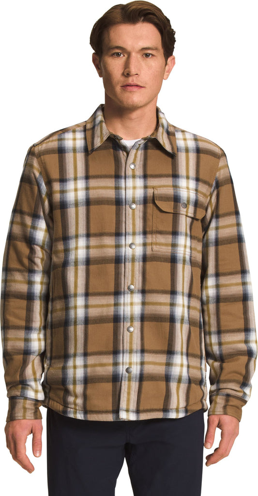Man wearing a plaid, button-down, long-sleeved flannel shirt.