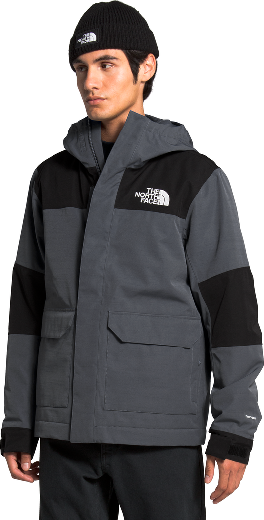 Man wearing a black beanie and a gray and black jacket with the text "THE NORTH FACE" in white.