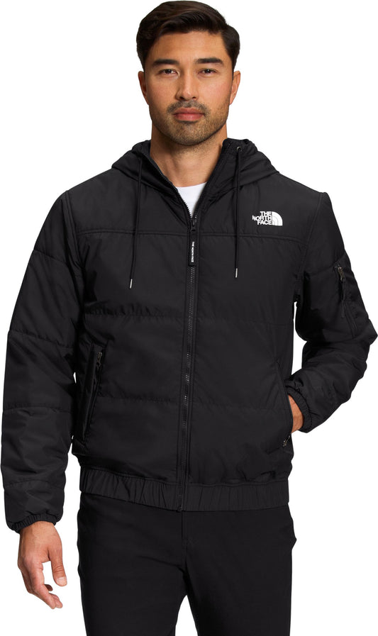 A man is wearing a black hooded zip-up jacket.
