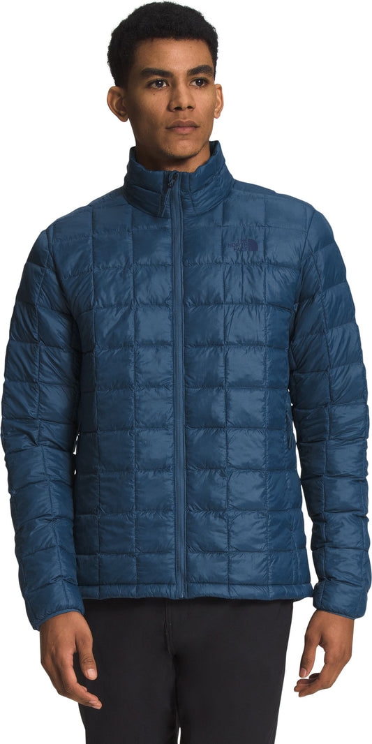 Blue quilted jacket with zipper.