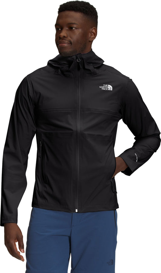 A black hooded jacket worn by a Black man with a hand in his right pocket.
