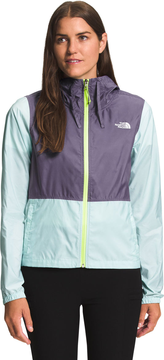 A woman is wearing a two-tone jacket with a zipper.