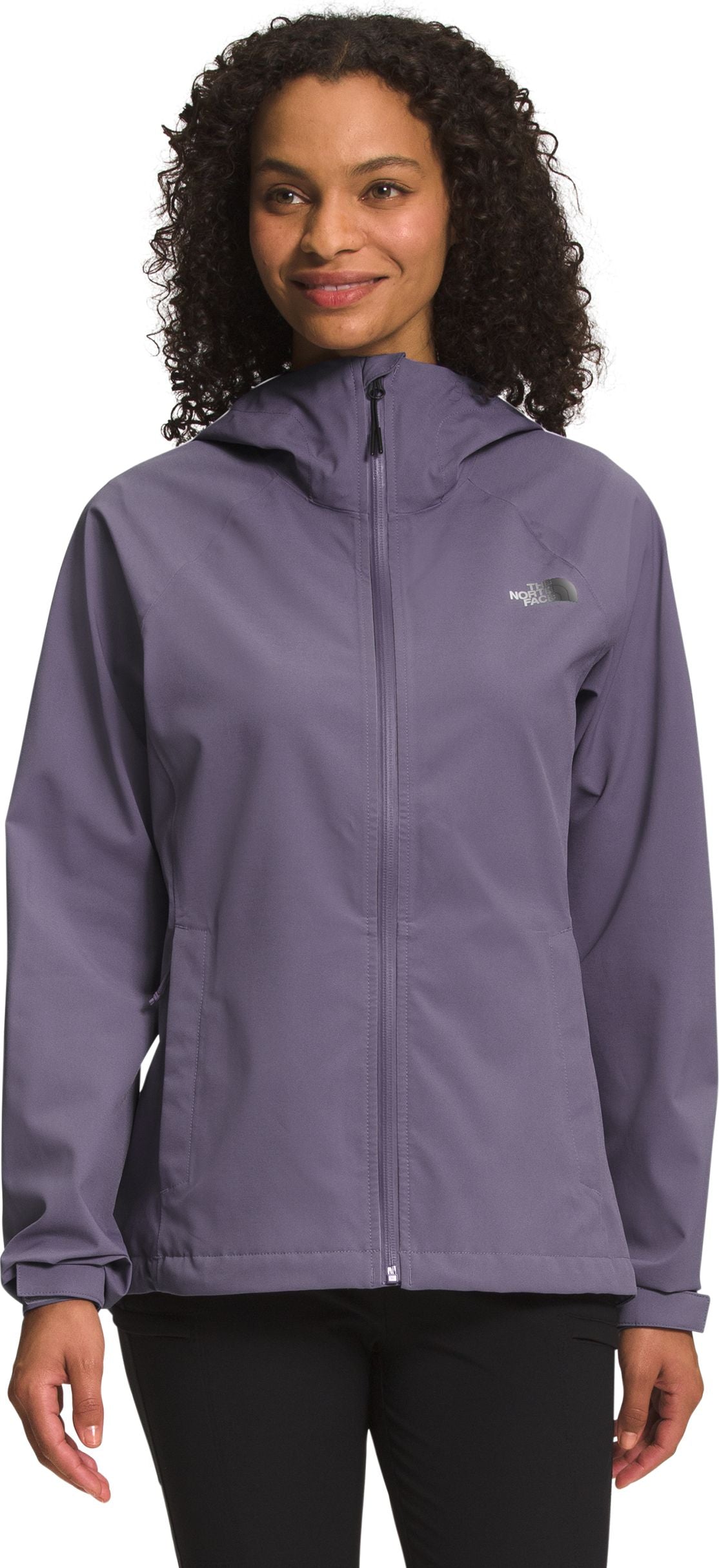 A woman wearing a muted purple hooded jacket.