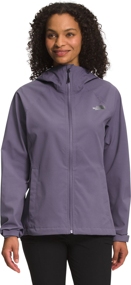 A woman wearing a muted purple hooded jacket.