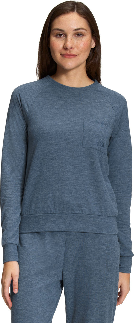 A woman wearing a blue, long-sleeved shirt.