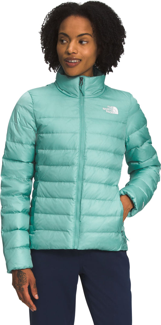 A person wearing a shiny turquoise puffer jacket.