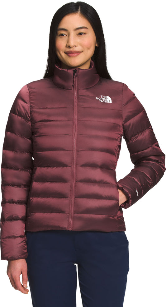 A person wearing a maroon puffer jacket with a zipper.