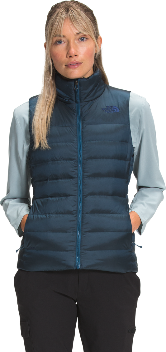 A woman wearing a puffy dark-blue vest.