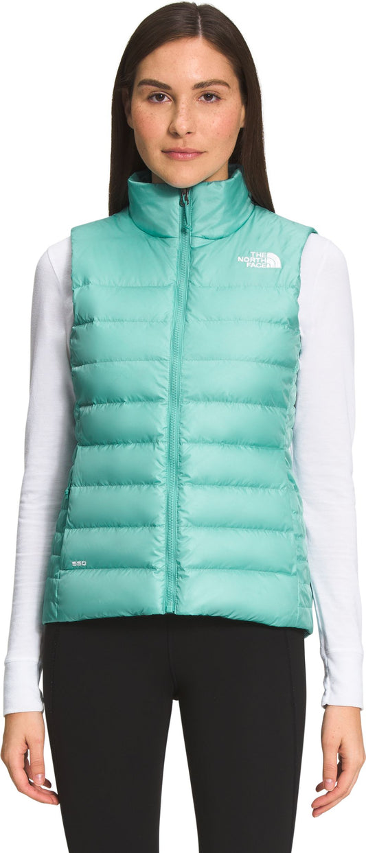 A woman wearing a light green puffer vest.