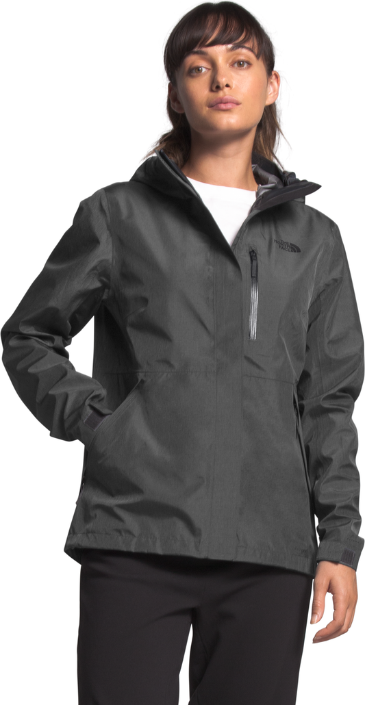 A woman wearing a gray rain jacket with a hood and pockets.