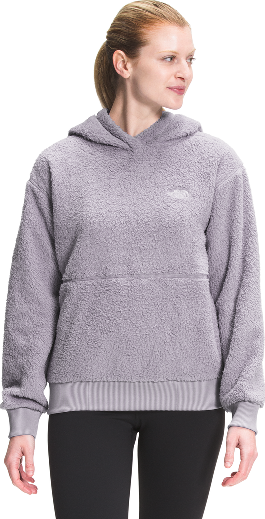 Woman wearing a light purple, fuzzy hoodie with a front pocket and gathered sleeves.
