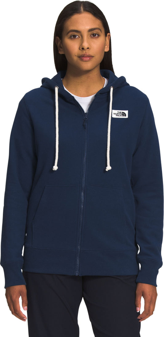 A person wearing a navy zip-up hooded sweatshirt with white drawstrings.