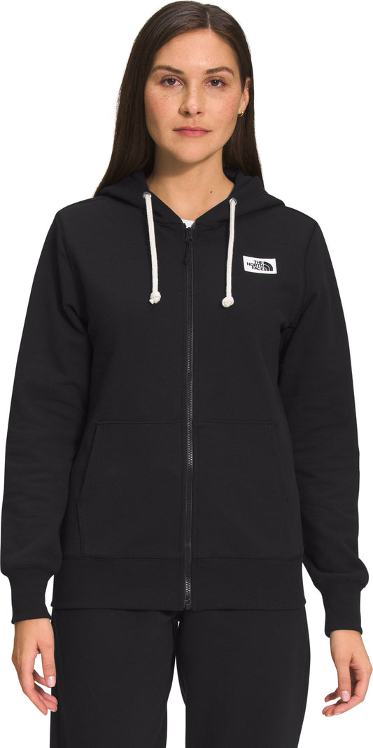 A woman in a zipped hooded sweater with drawstrings.