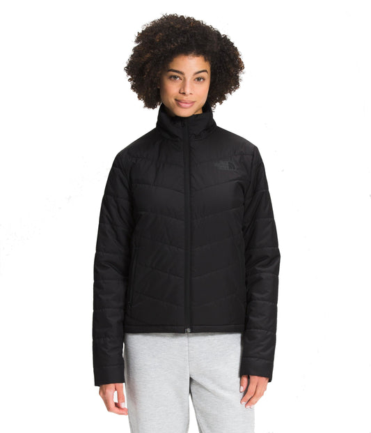 A woman wearing a black puffy jacket and gray sweatpants.