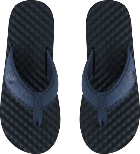 Pair of navy blue flip-flops, top view.