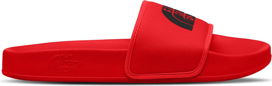 A red slide sandal with an adjustable upper strap, featuring a black logo.