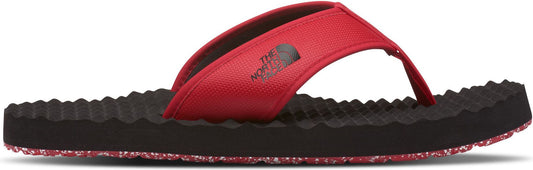 A red and black flip-flop with a textured sole.